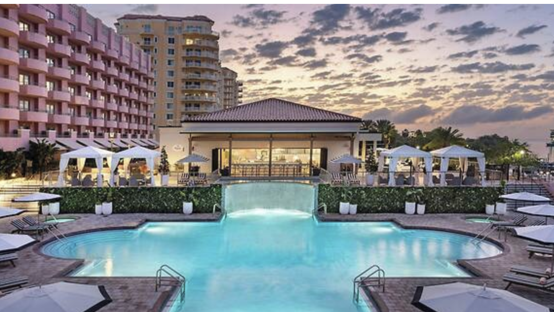 Upscale resort pool and outdoor guest setting.